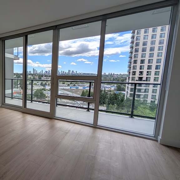 a room with a view of a cityscape through large windows.