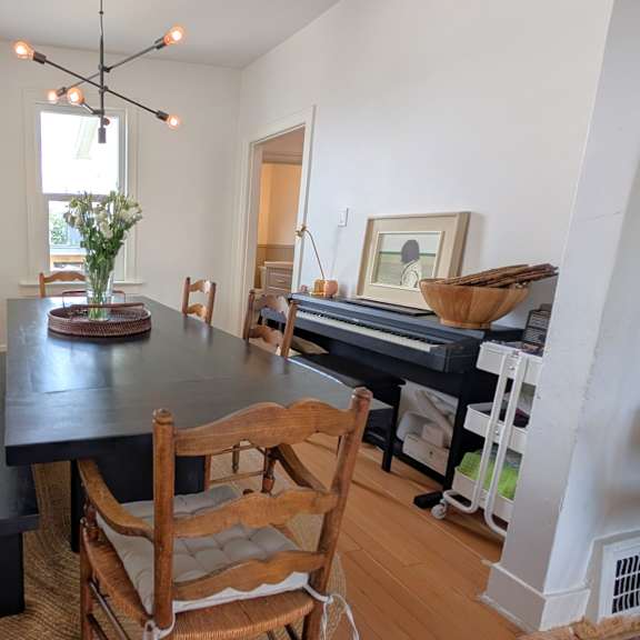 a dining room with a table and chairs.