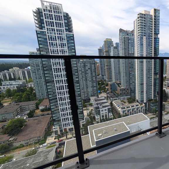 a balcony overlooks a cityscape with tall buildings.