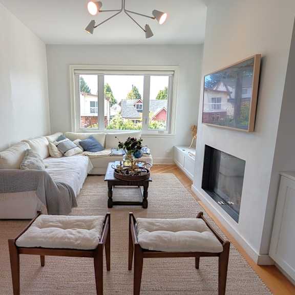 a living room with a couch, a coffee table, and a fireplace.