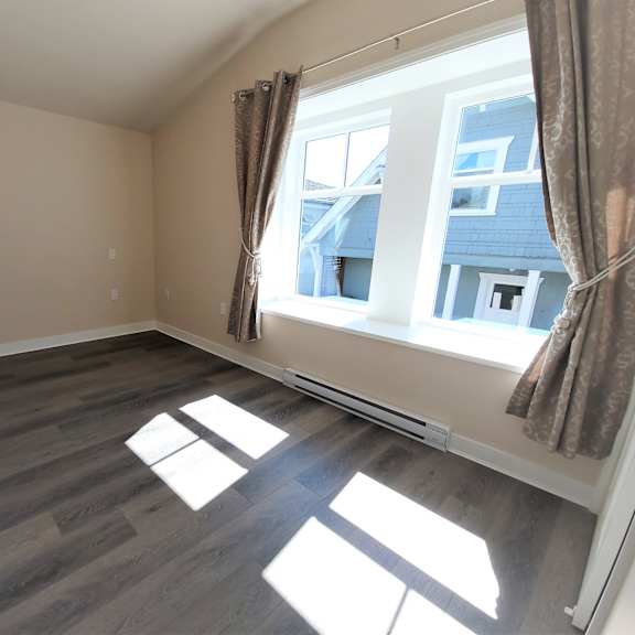 a room with a window and a view of a building outside.