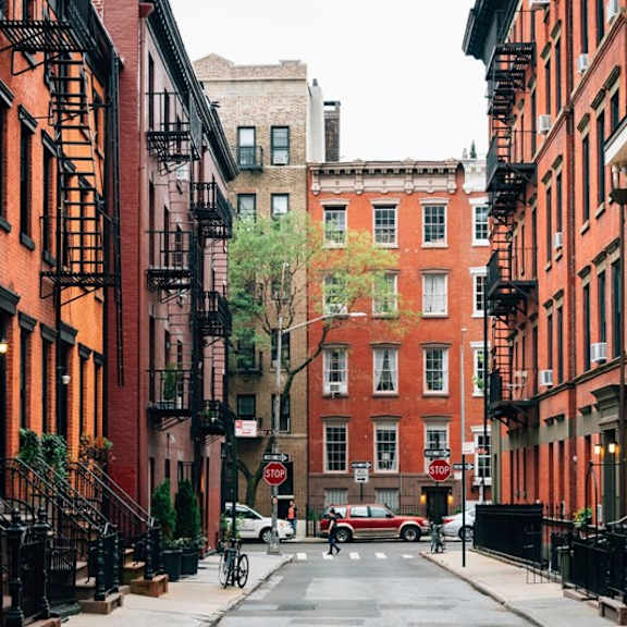 a red car is parked on the street.