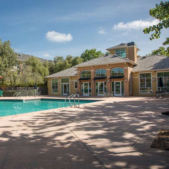 a swimming pool with a building in the background