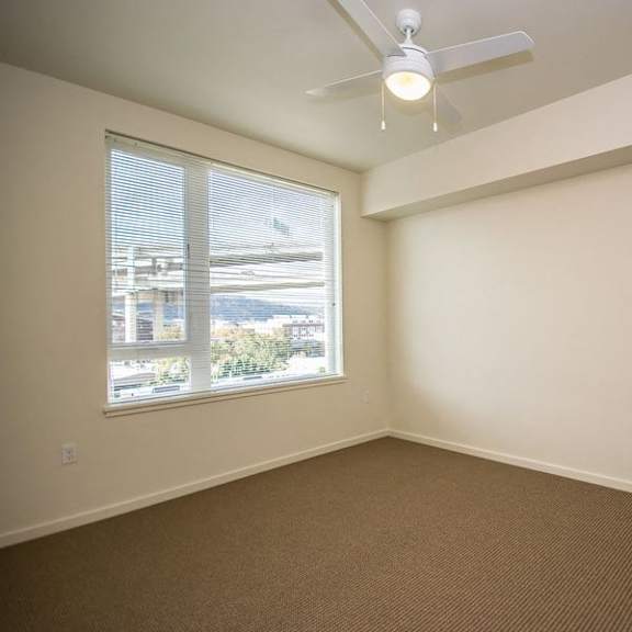bedroom with fan and window