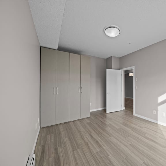 an empty living room with white walls and wood flooring