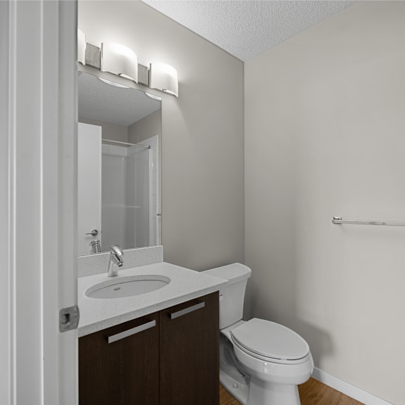 an empty bathroom with a toilet sink and mirror