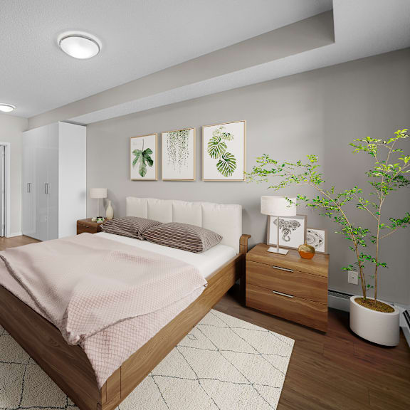 a bedroom with white walls and wood floors and a bed