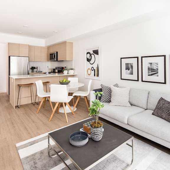 a modern living room with a white couch and a coffee table.