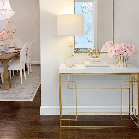 Thumbnail 2 of 3 a white desk with a mirror and a table in a room