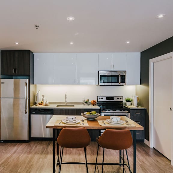 a modern kitchen with a dining table and chairs.