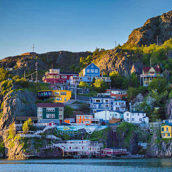 a small town is built into the side of a cliff.