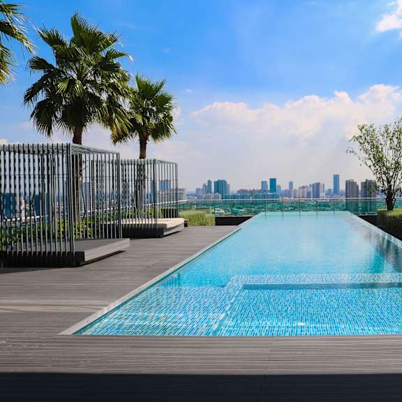 the infinity pool on the roof of a skyscraper overlooking the city