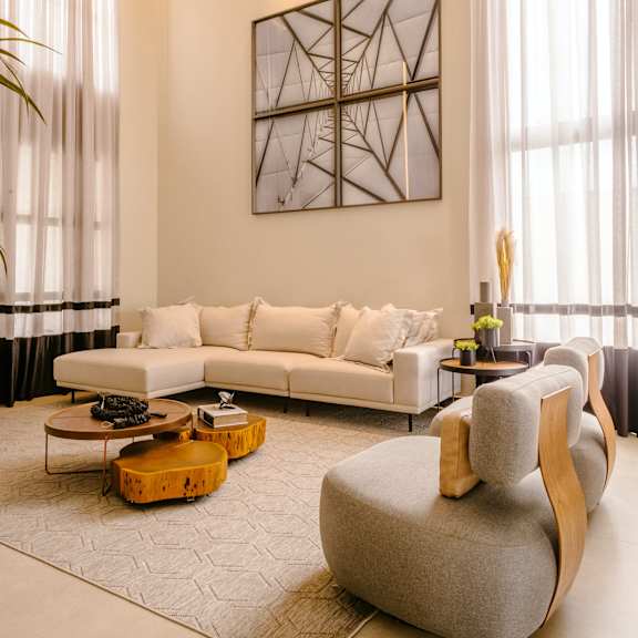 a living room filled with furniture and a large window