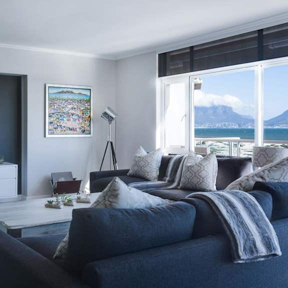 a living room with a grey couch and a television.