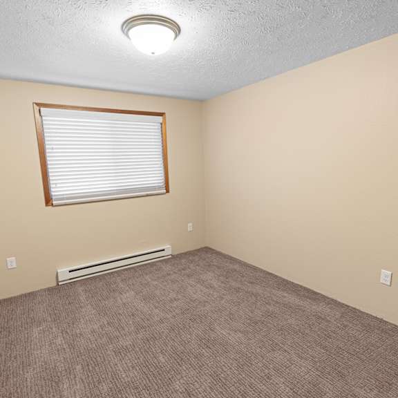 a room with a window and a heater.