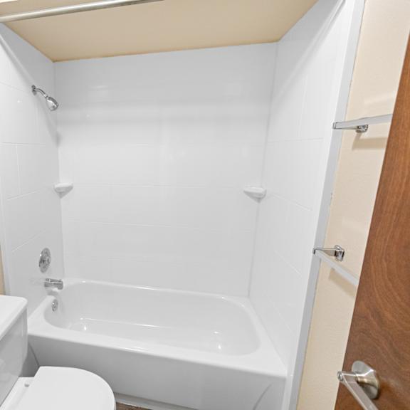 a white toilet and sink in a small bathroom.