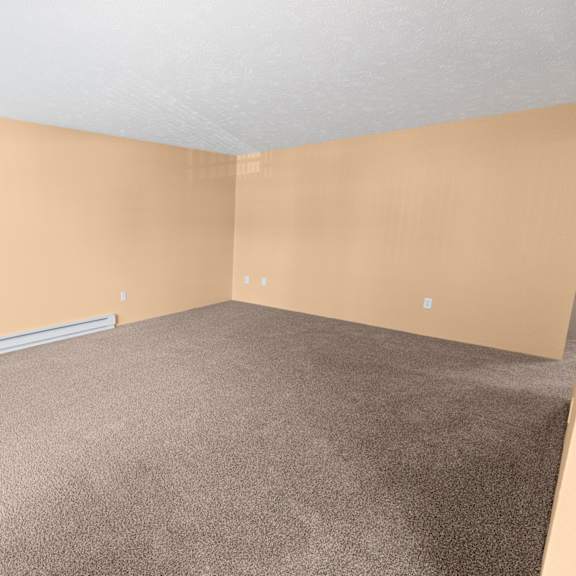a room with a carpeted floor and a window with blinds.