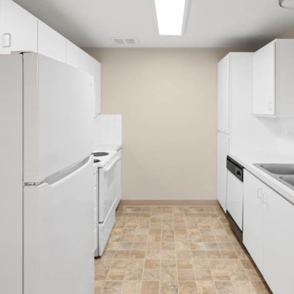 a kitchen with white appliances and cabinets.