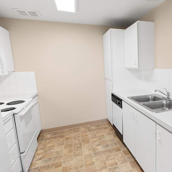 a kitchen with white appliances and cabinets.