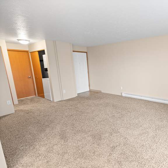 a room with a carpeted floor and a white ceiling.