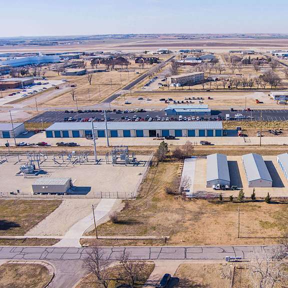 an aerial view of a large industrial area with multiple buildings and a parking lot.