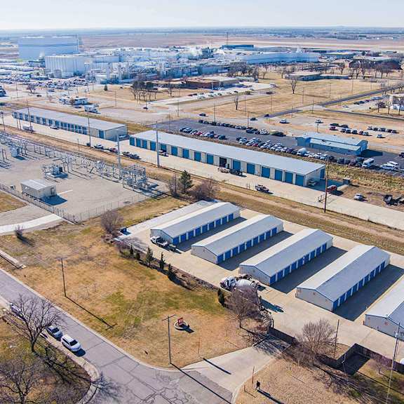 an aerial view of a large industrial area with multiple buildings and vehicles.