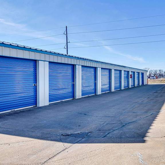 a long row of blue storage units with closed doors.