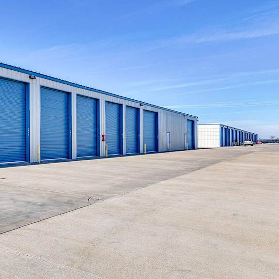 a long row of storage units with blue doors.