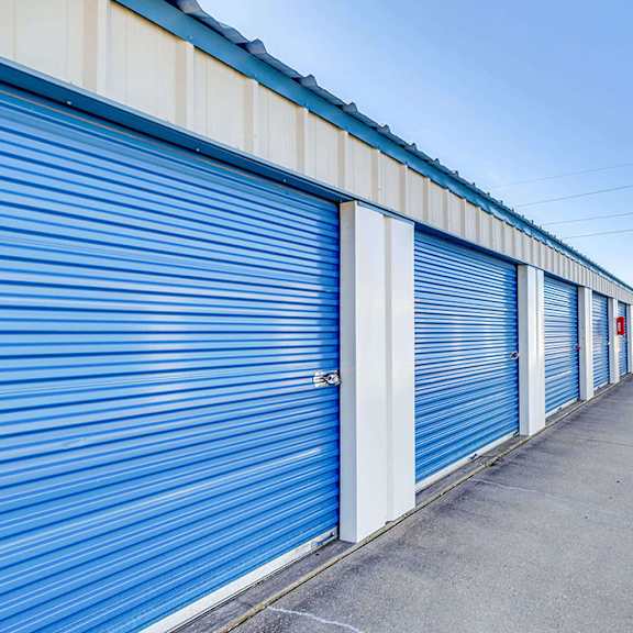 a long row of blue storage units with closed doors.