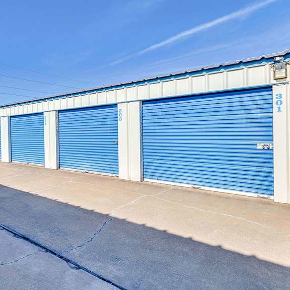 a long row of blue storage units with the number 301 on the side.