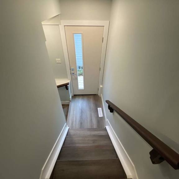 a long hallway with a door at the end.