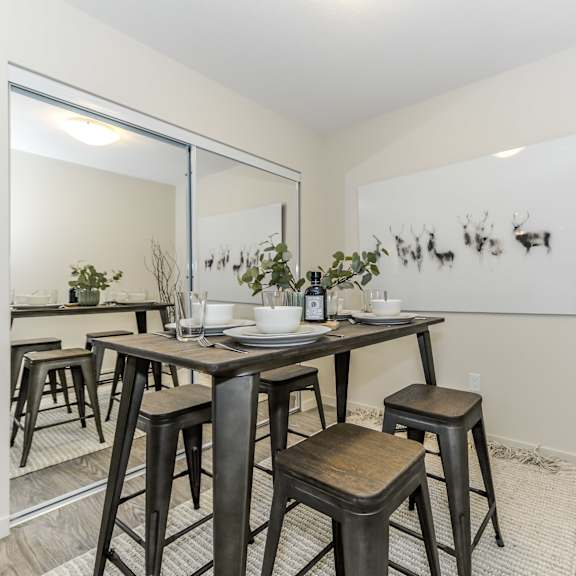 a dining room with a table and chairs.