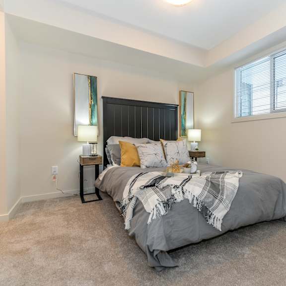 a bedroom with a large bed and two lamps on either side of it.