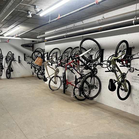 a bike rack with many bikes hanging on it.