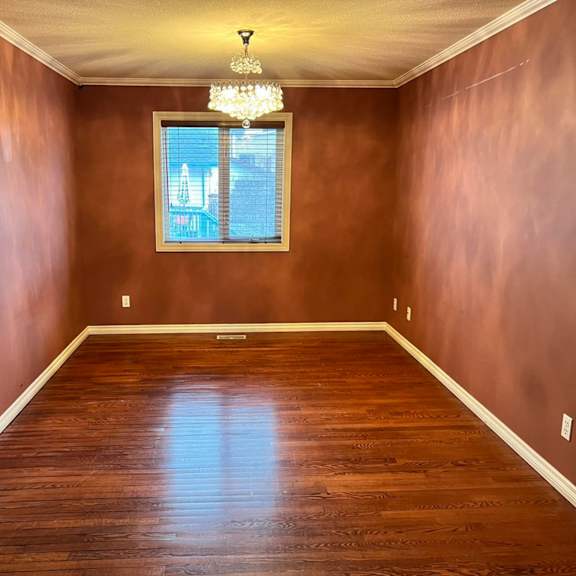 a room with brown walls and wooden flooring.