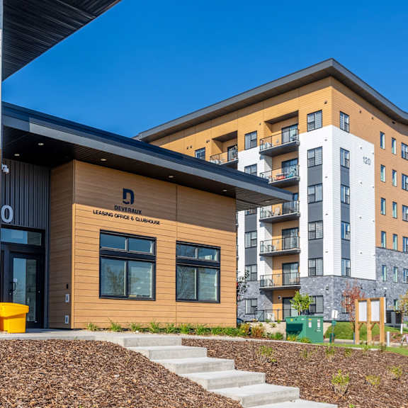 a modern building with a brown facade and a sign that reads
