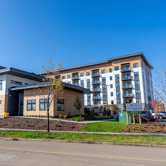 a modern building with a parking lot in front.