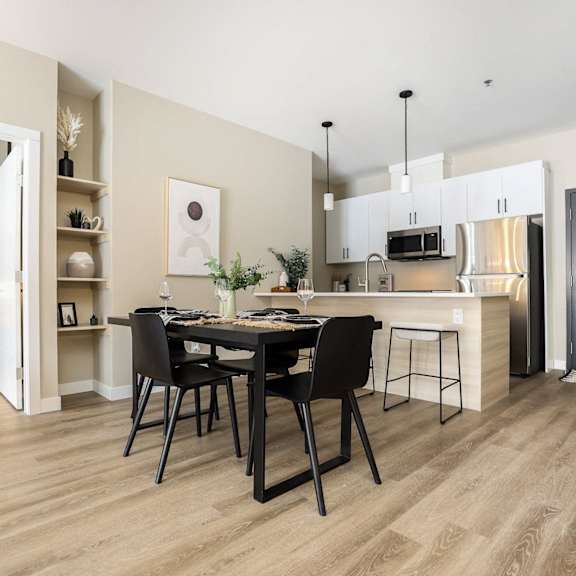 a modern kitchen with a dining table set for two.