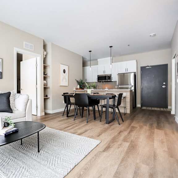 a modern living room with a white couch and a black coffee table.