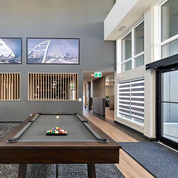 a living room with a pool table and a television