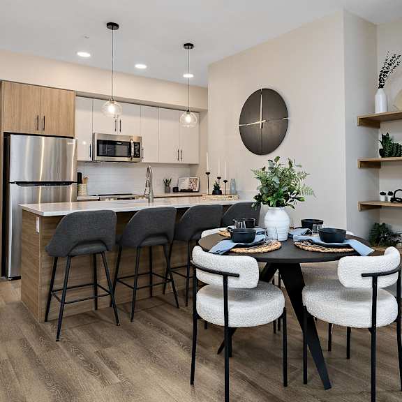 an open kitchen and dining room with a table and chairs