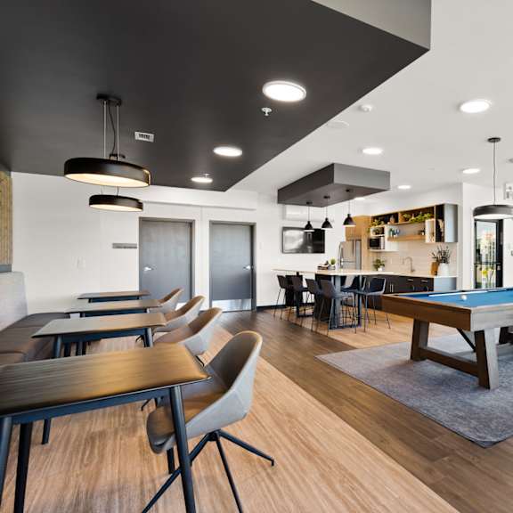 a modern room with a pool table and a bar.