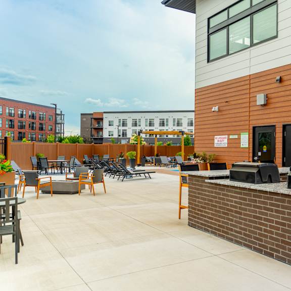a patio area with a bar and seating.