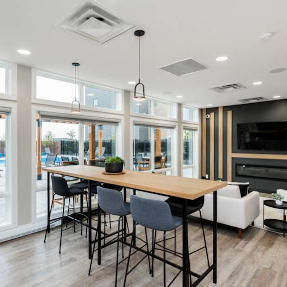 a modern dining room with a long table and chairs.