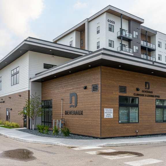 a modern building with a brown and white facade is labeled "deveraux.".