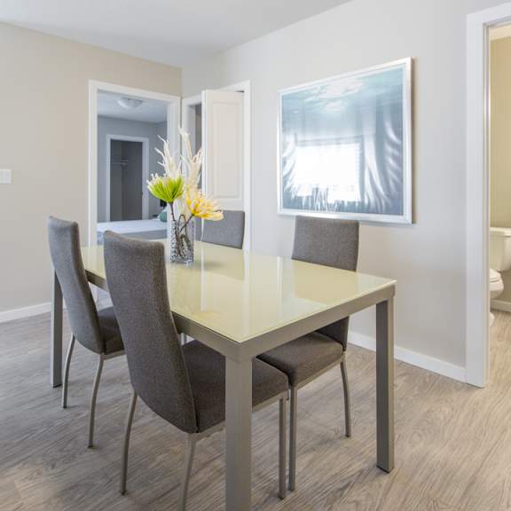 a dining room with a table and chairs.