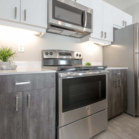 a modern kitchen with a stainless steel refrigerator, oven, and microwave.