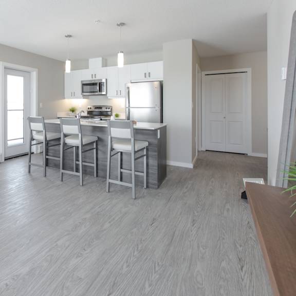 a modern kitchen with a dining table and chairs.