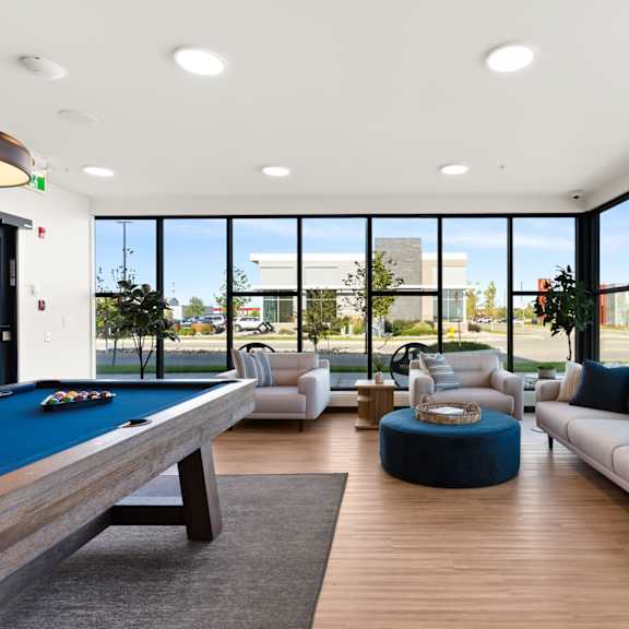 a room with a pool table and a couch.