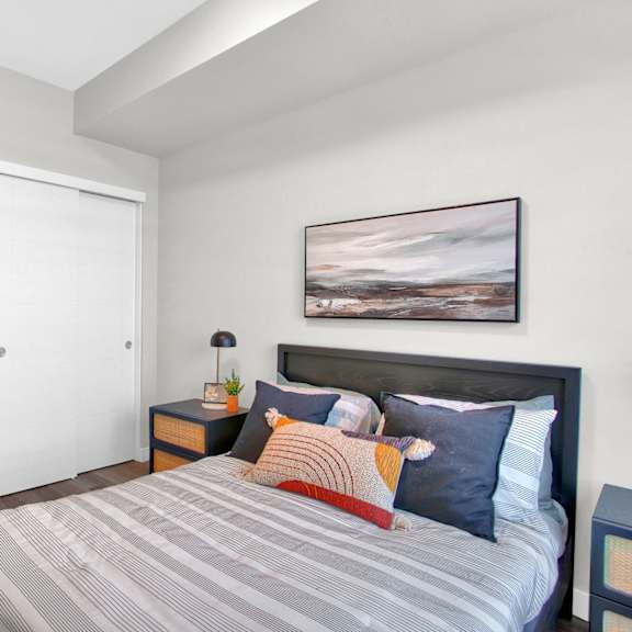 modern bedroom with in unit laundry at plaza apartments, calgary